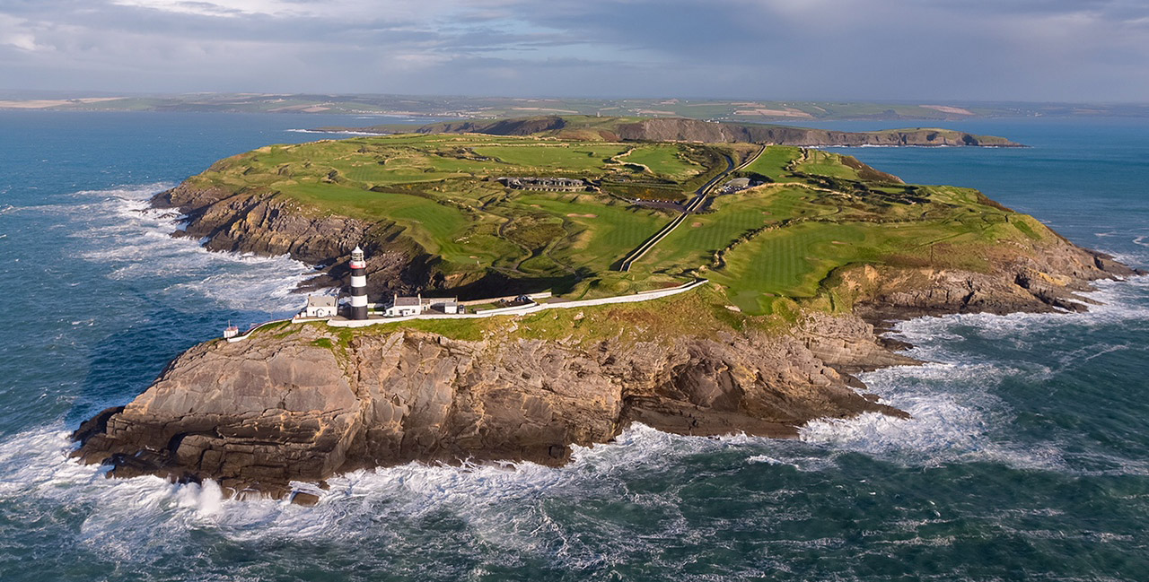 Aerial photograph of Old Head Golf Links and its lighthouse on a dramatic Atlantic headland